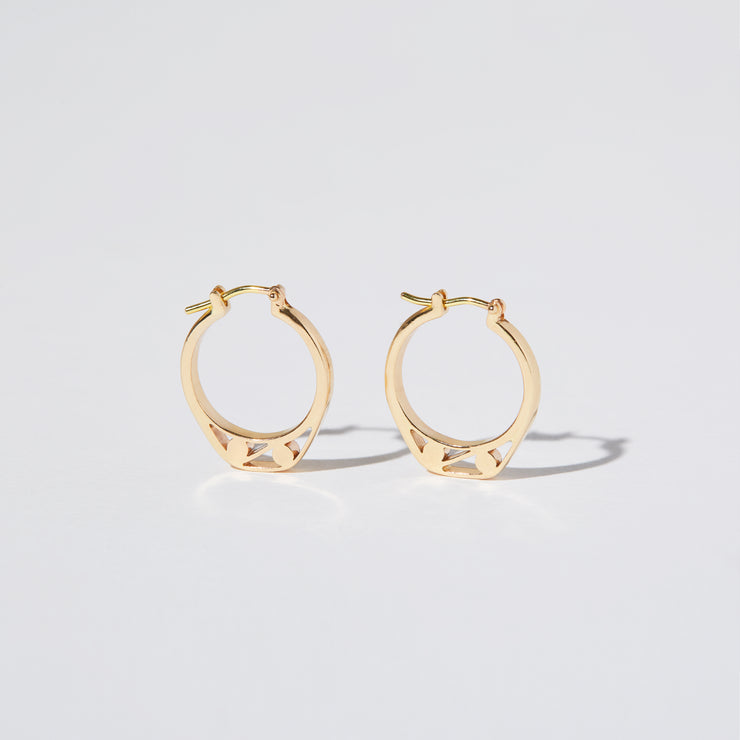 Detail of Gold hoops on a model. 14K Gold hoops with graphic details reminiscent of lace. These Earrings are made of Fairmined Gold, extracted from Fair trade mines in Colombia and Peru.
