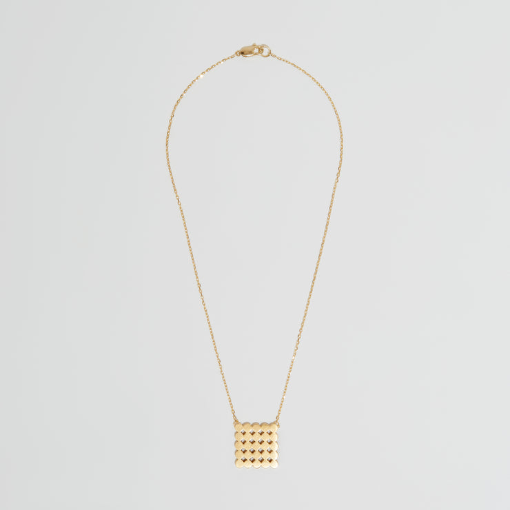 gold pendant representing circles in a square on gold chain