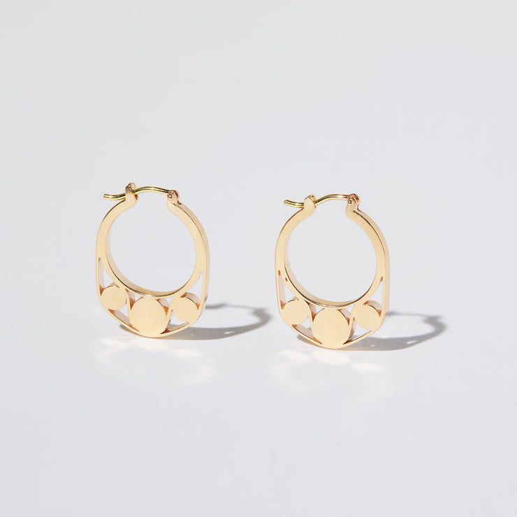 Detail of Gold hoops on a model. 14K Gold hoops with graphic details reminiscent of lace. These Earrings are made of Fairmined Gold, extracted from Fair trade mines in Colombia and Peru.