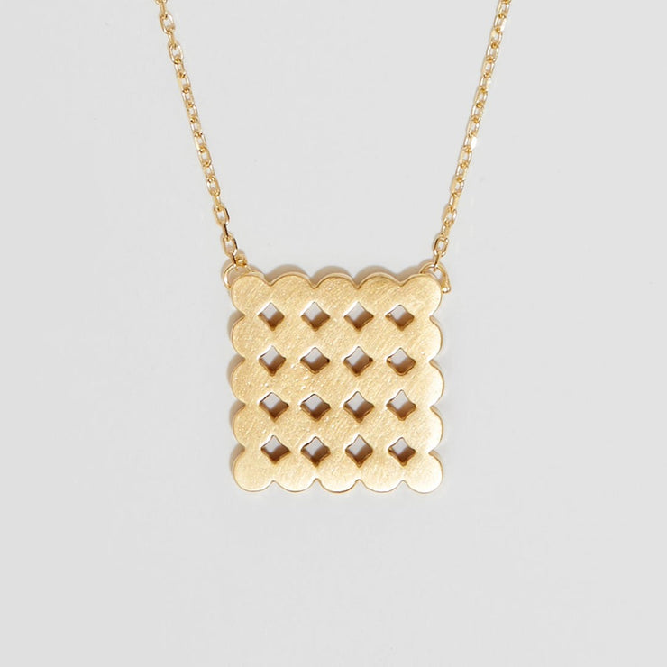 gold pendant representing circles in a square on gold chain 