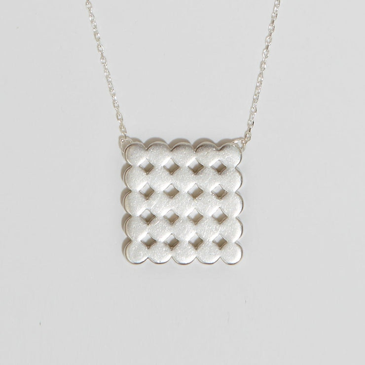 Silver pendant representing circles in a square on silver chain 