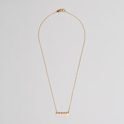 gold plated sterling silver necklace of the row of circle attached to fine chain.