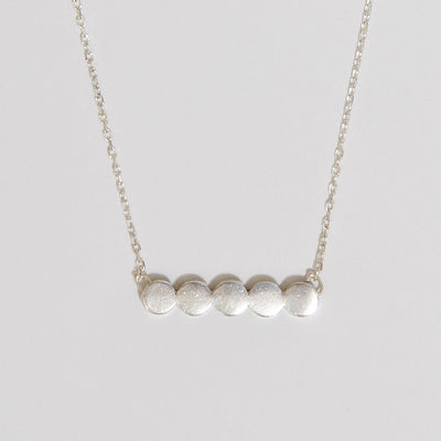 sterling silver necklace of the row of circle attached to fine chain.