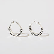Silver hoops with graphic details reminiscent of lace