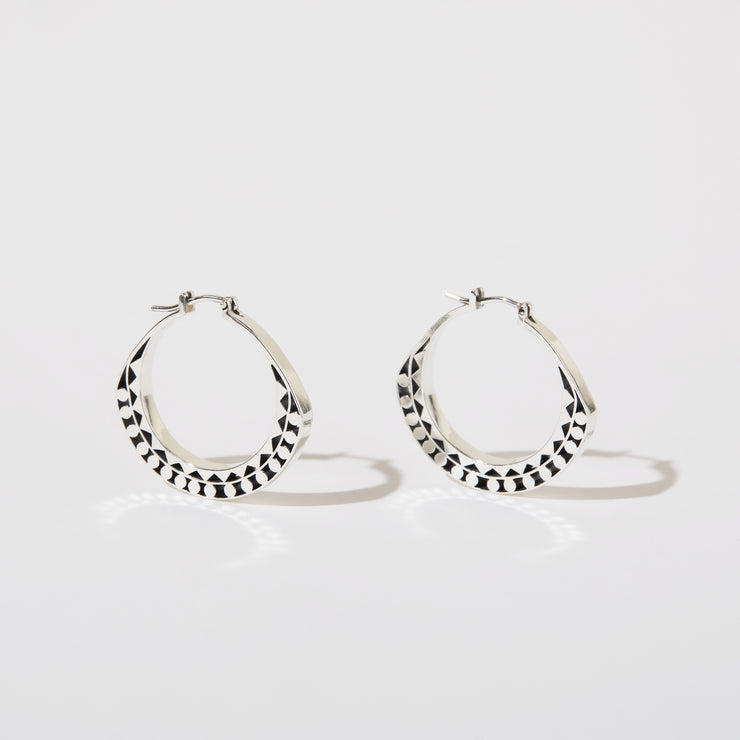Silver hoops with graphic details reminiscent of lace