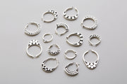 grouping of silver hoops with graphic details 