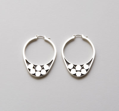 Silver hoops with graphic details reminiscent of lace