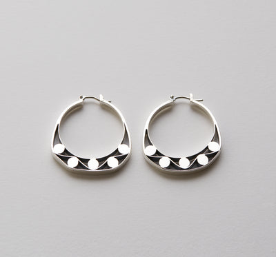 Silver hoops with graphic details reminiscent of lace