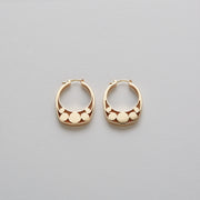 Detail of Gold hoops on a model. 14K Gold hoops with graphic details reminiscent of lace. These Earrings are made of Fairmined Gold, extracted from Fair trade mines in Colombia and Peru.